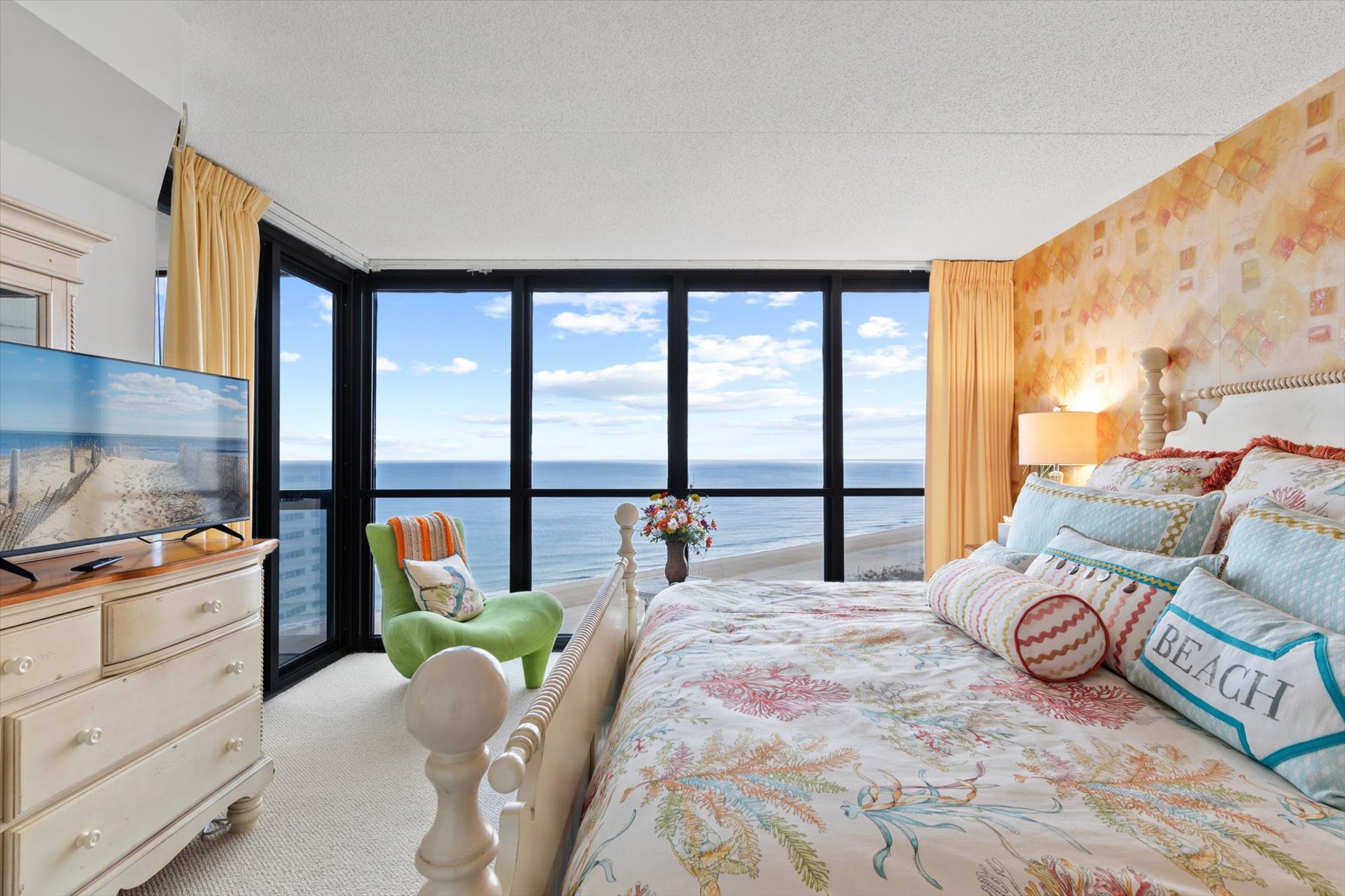 Primary bedroom is bright and beachy with a beautiful view!
