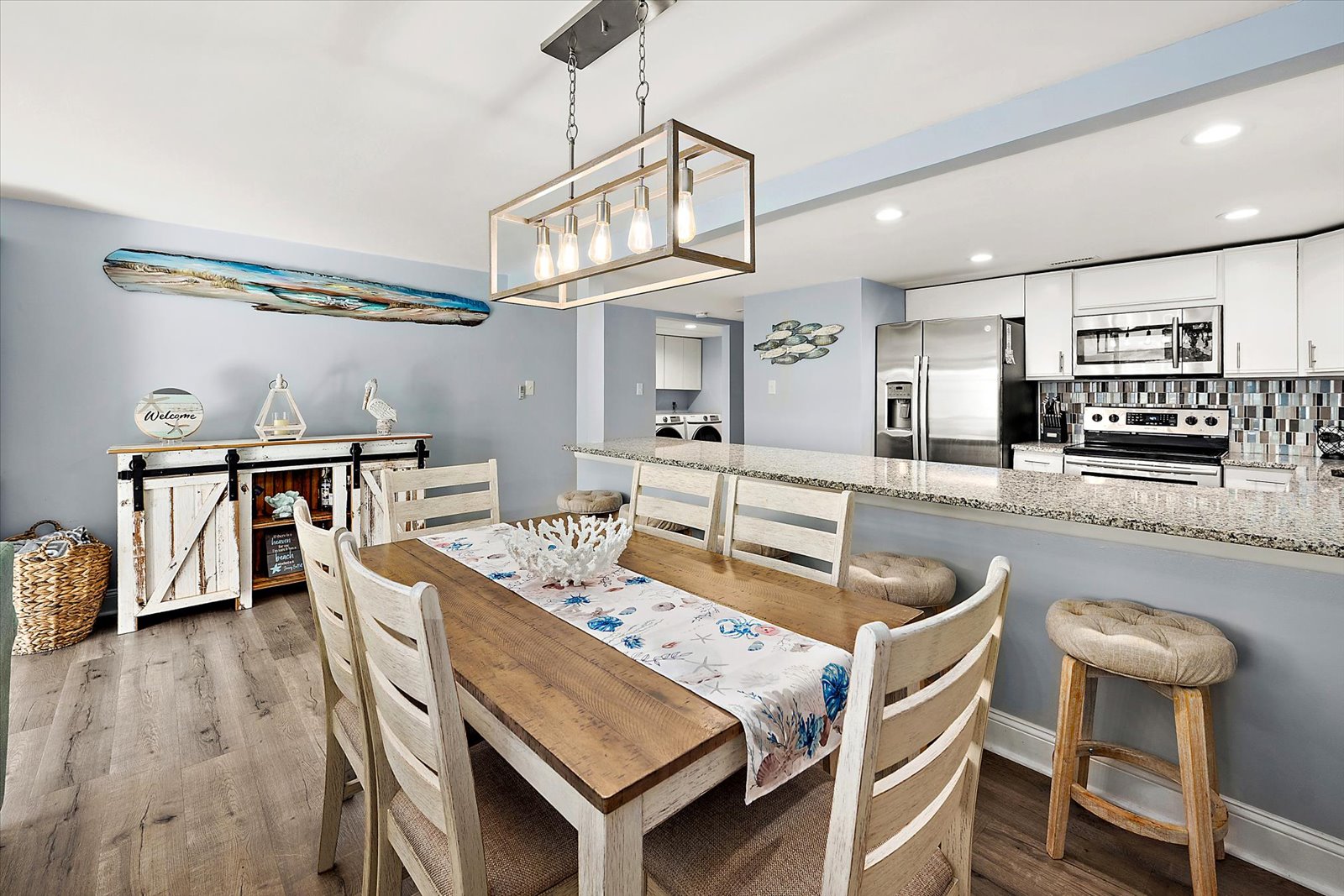 Enjoy memorable meals at the elegant dining table, beautifully lit and situated right next to the heart of the home.