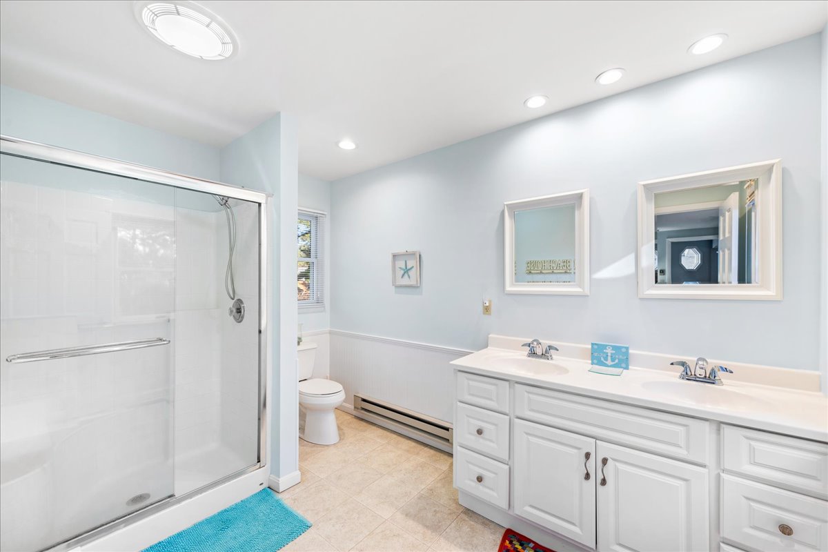 Private En-Suite Bath with Double Vanity and Walk-in Shower.