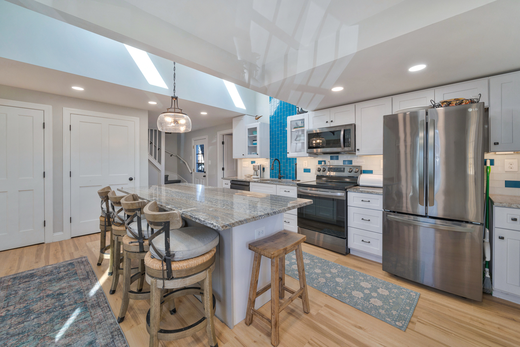 Spectaular Kitchen with Stainless Appliances and gleaming Quartz Countertops.