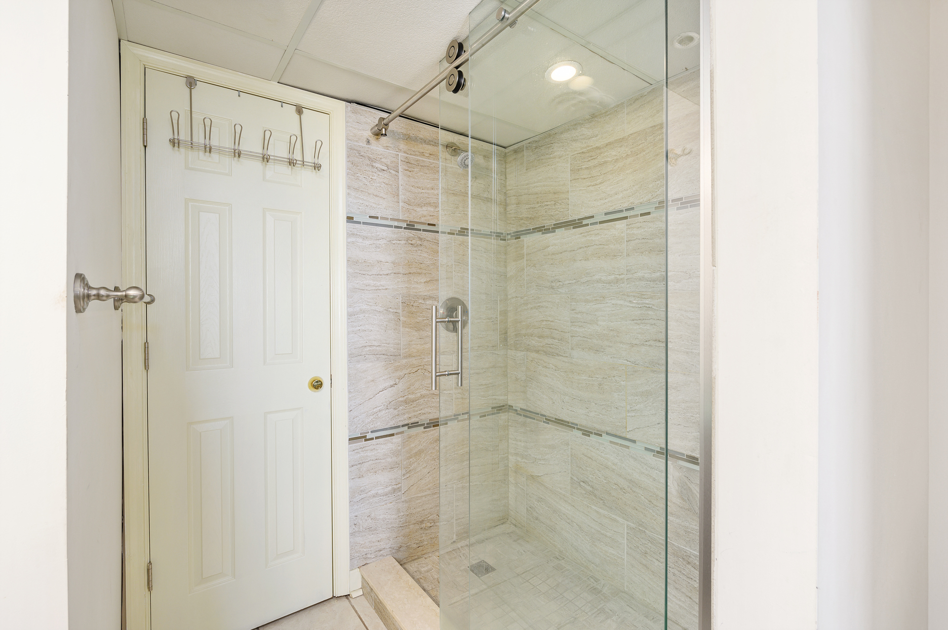 All your worries will wash away in the beautiful custom tiled Primary Shower.