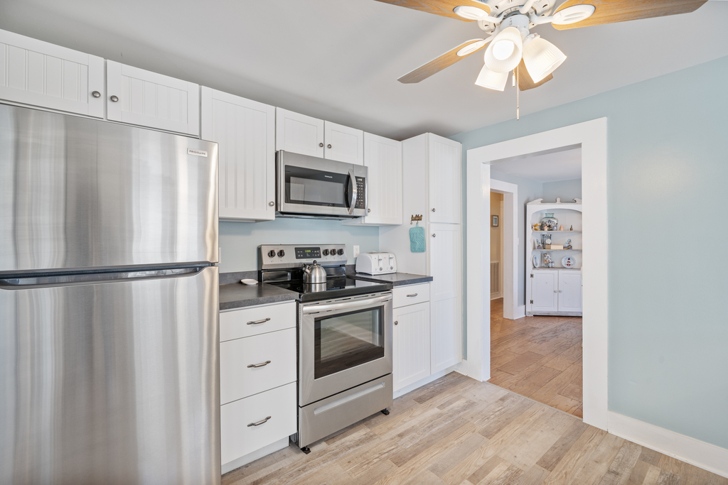 Stainless Appliances and beach white cabinetry.