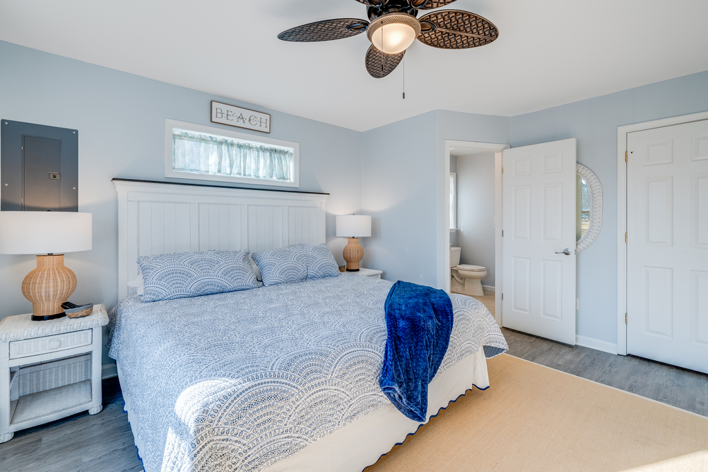 Bedroom 1 is decked out in crisp white and nautical navy.