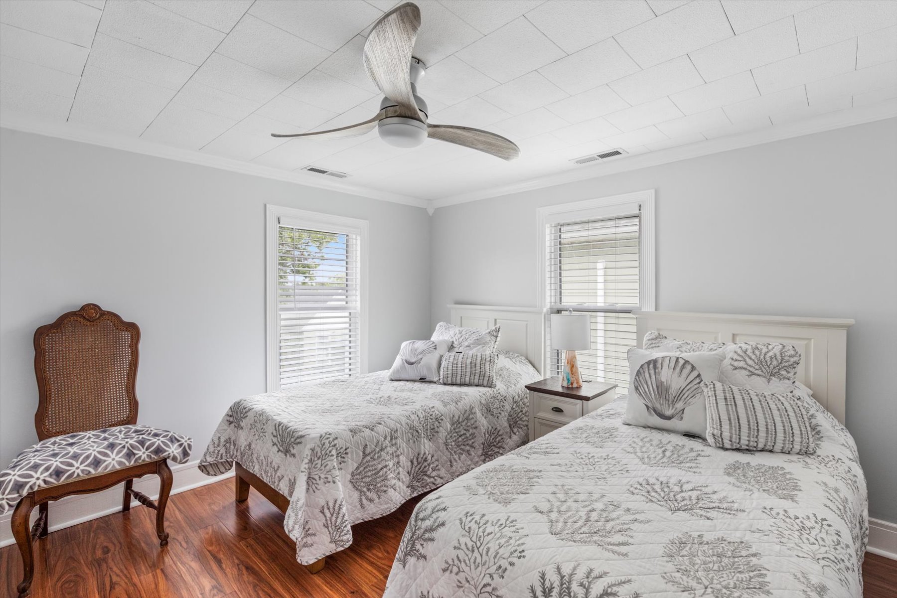Bedroom 2 has 2 Twin Beds and a relaxing color palette.
