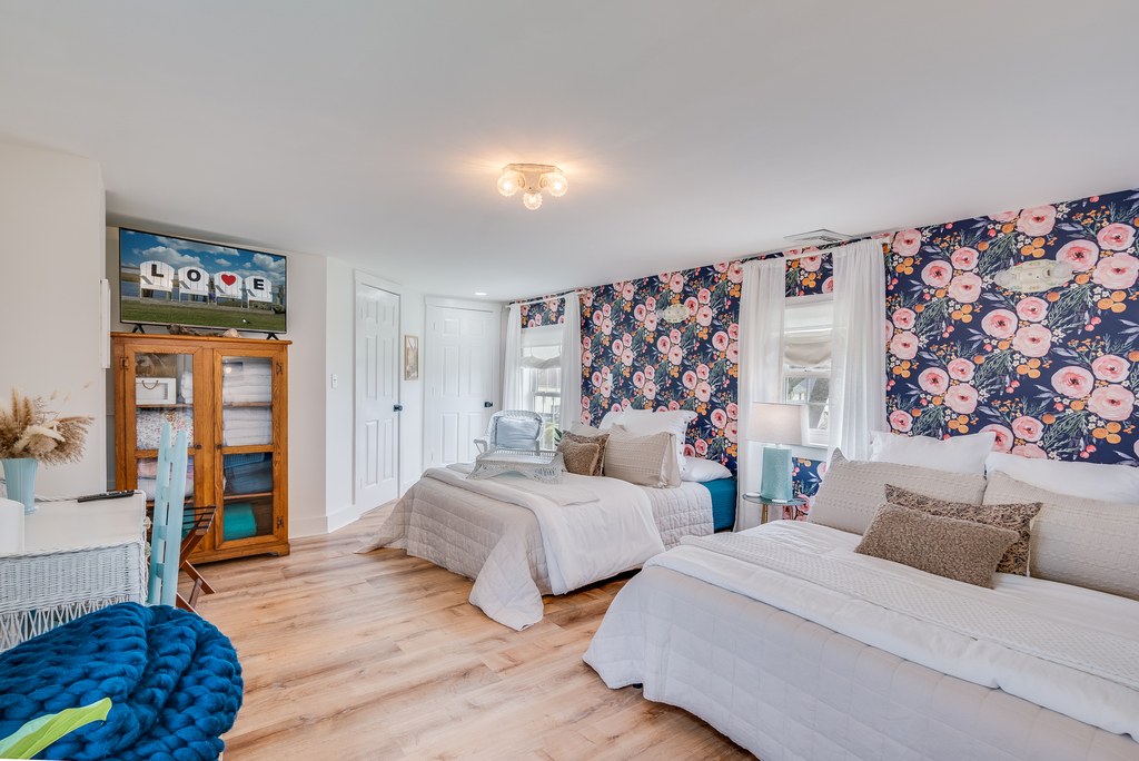 Bedroom 2 has 2 Queen Beds and a charming shabby chic decor.