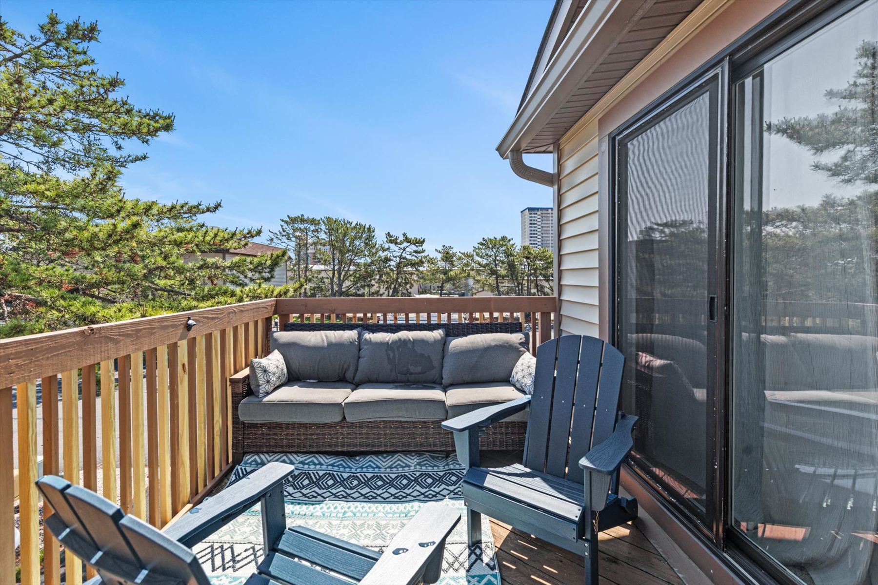 Enjoy the sunshine on the upper-level private deck, fully equipped with a comfortable outdoor sofa and chairs.