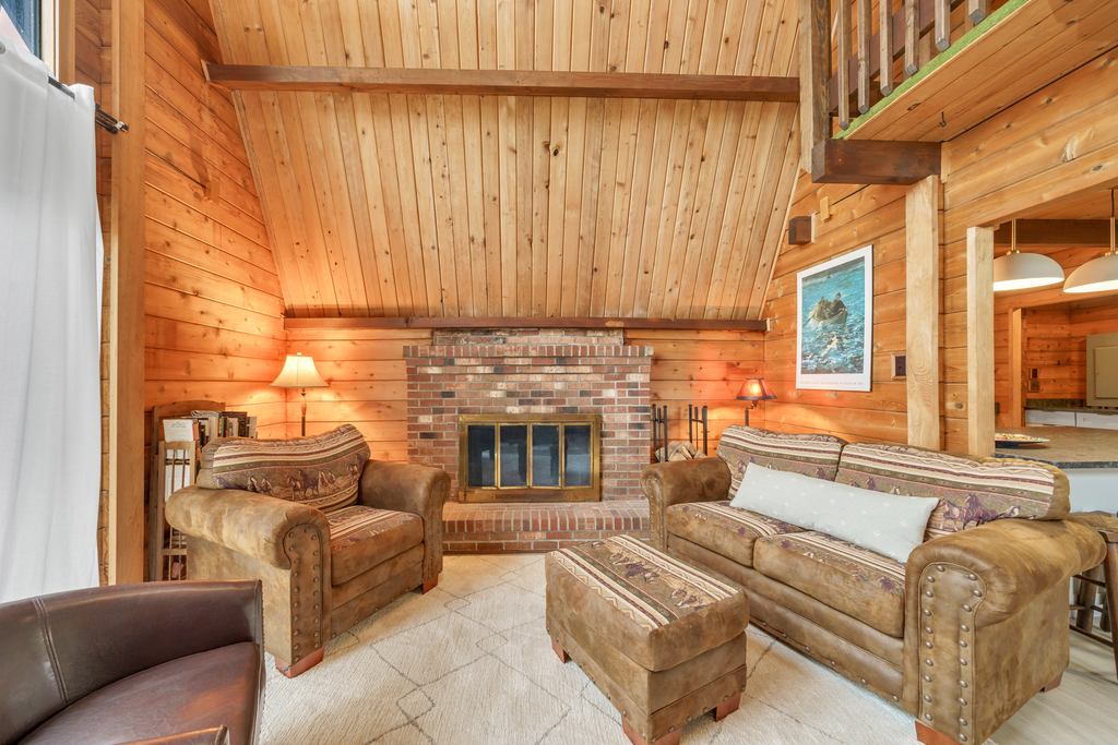A cozy Vacation Home with Warm Wood and Soaring Ceilings. (Fireplace decorative only)