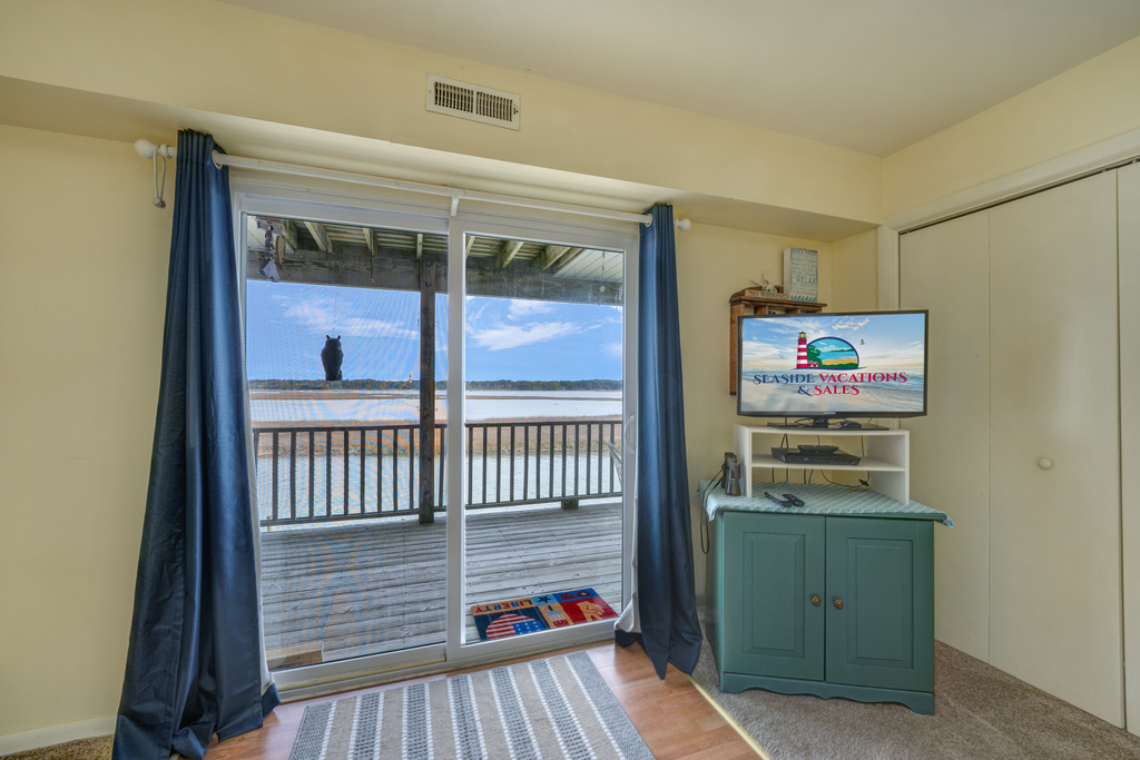 Waterfront Balcony and Flat Screen TV in Bedroom 1.