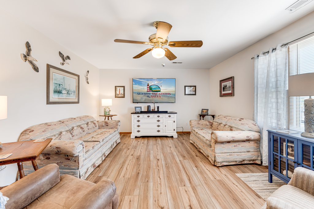 Cozy Living Area with comfy Furnishings and 70 inch Flat Screen Smart TV.