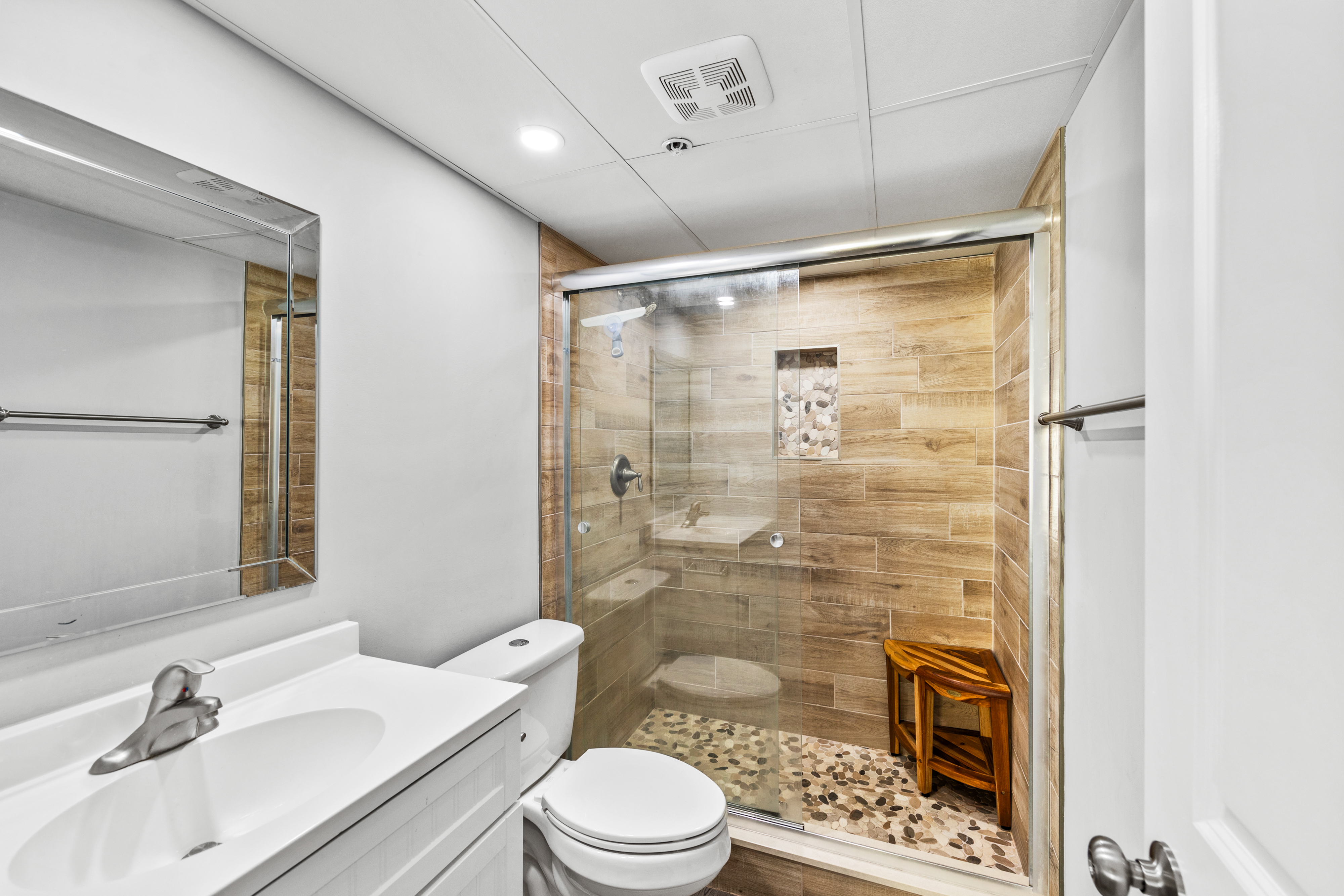 Wash away the sand from the day in the gorgeous custom tile walk-in shower.