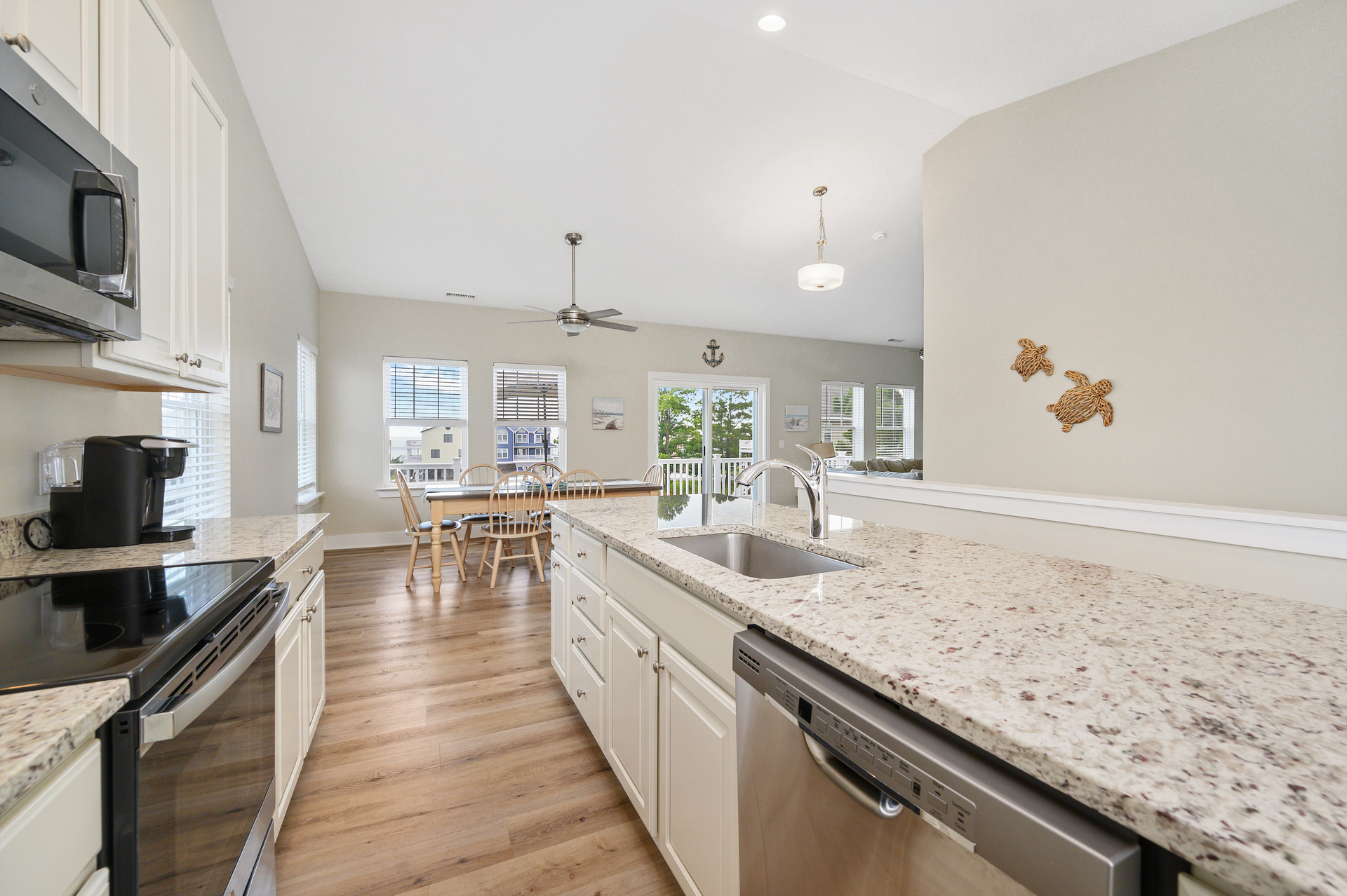 Gleaming Granite and Stainless Appliances.