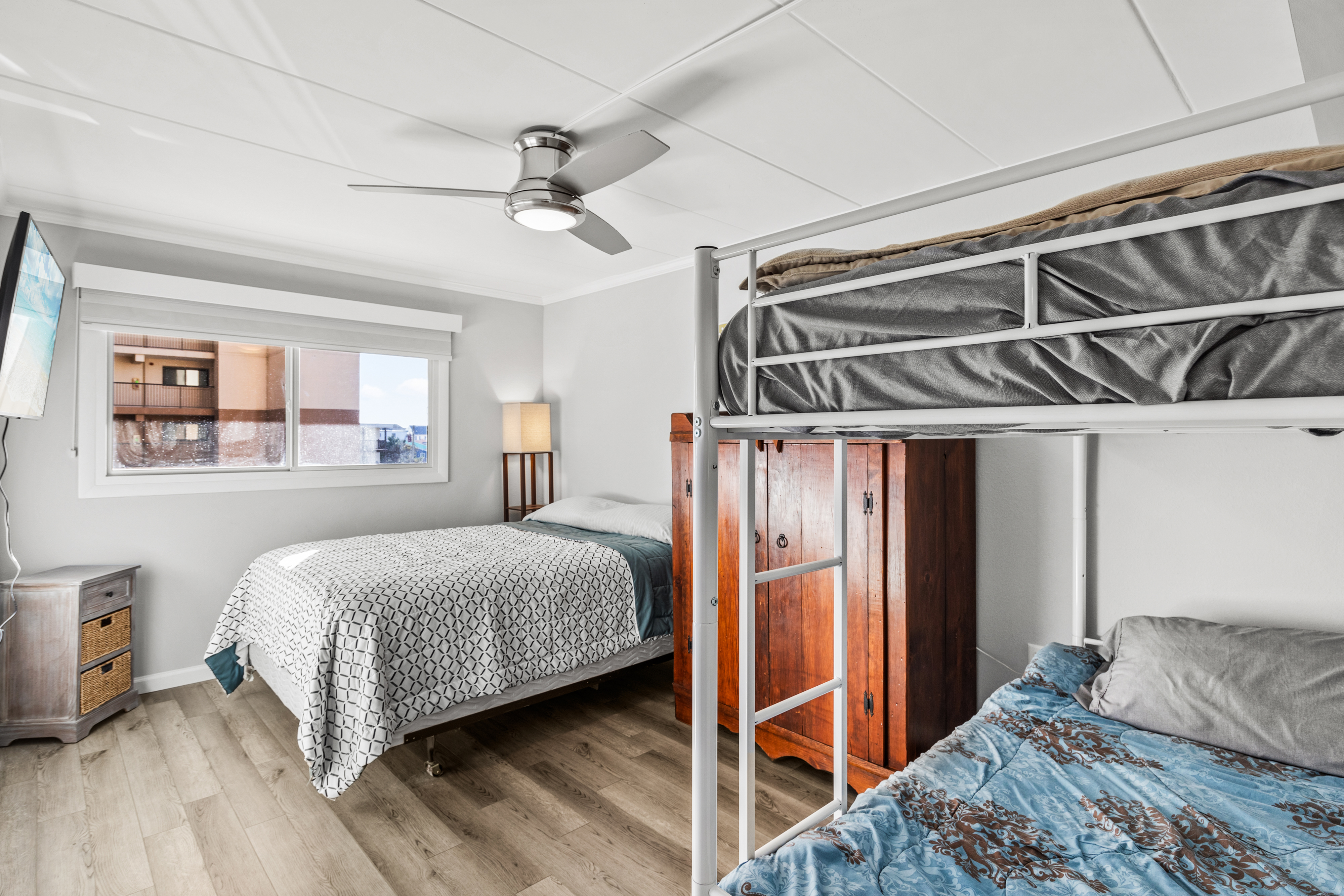 Bedroom 2 features a set of twin bunk beds and a queen bed.