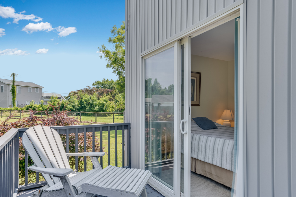 Bedroom 2 has access to back Deck with seating.