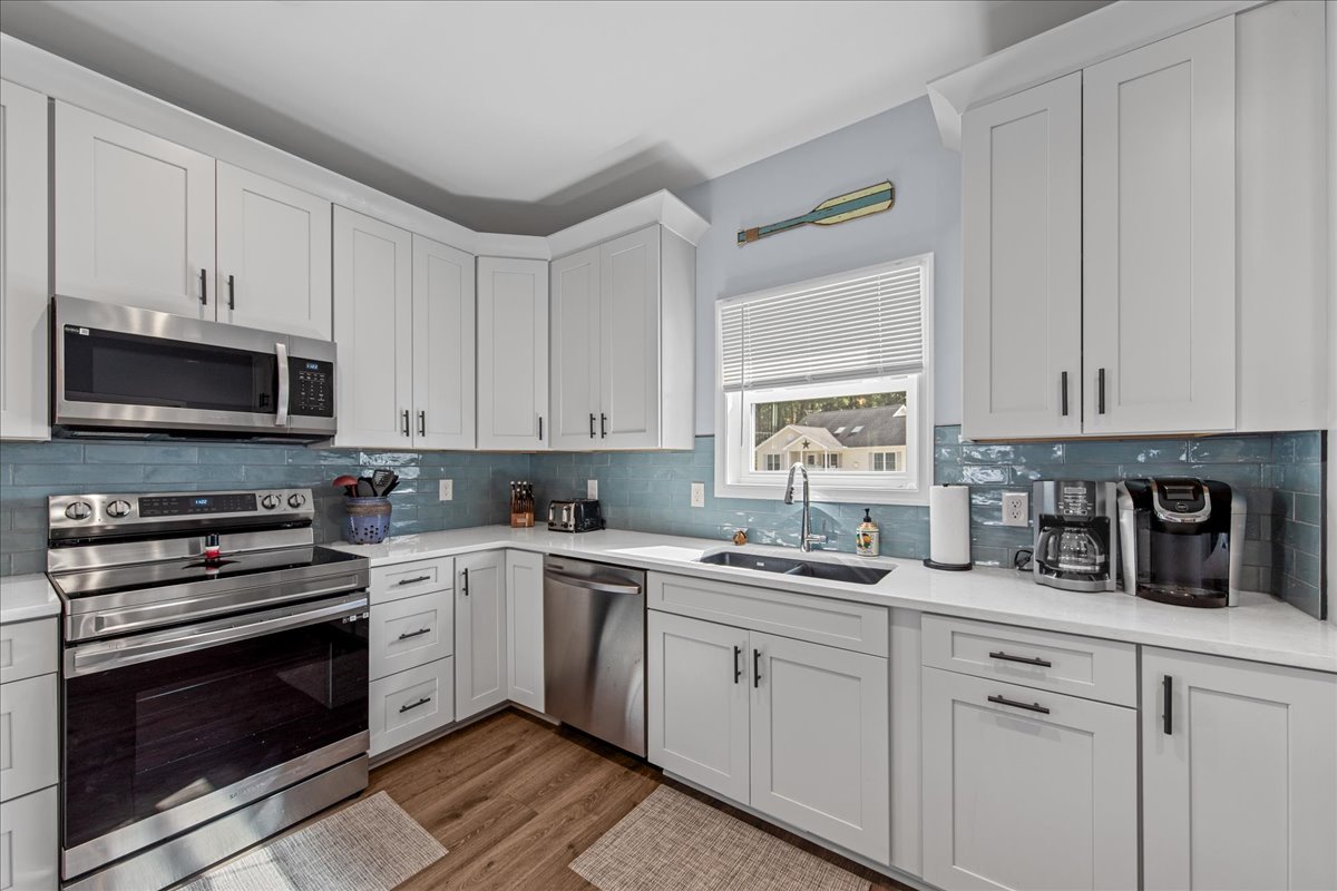 Gleaming Granite and Stainless Appliances.