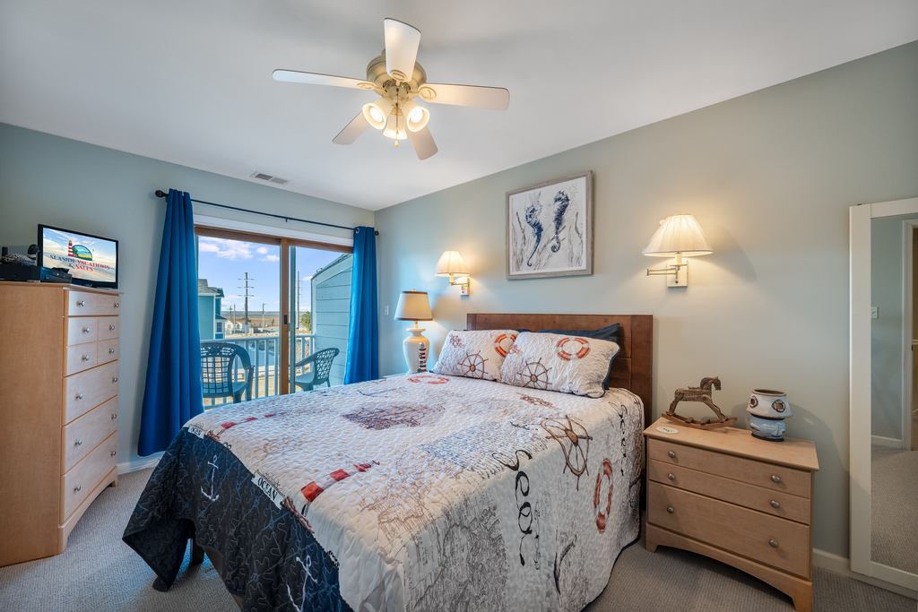 Upstairs, Bedroom 1 has a comfy Queen Bed, Coastal Decor, and Private Waterfront Balcony.