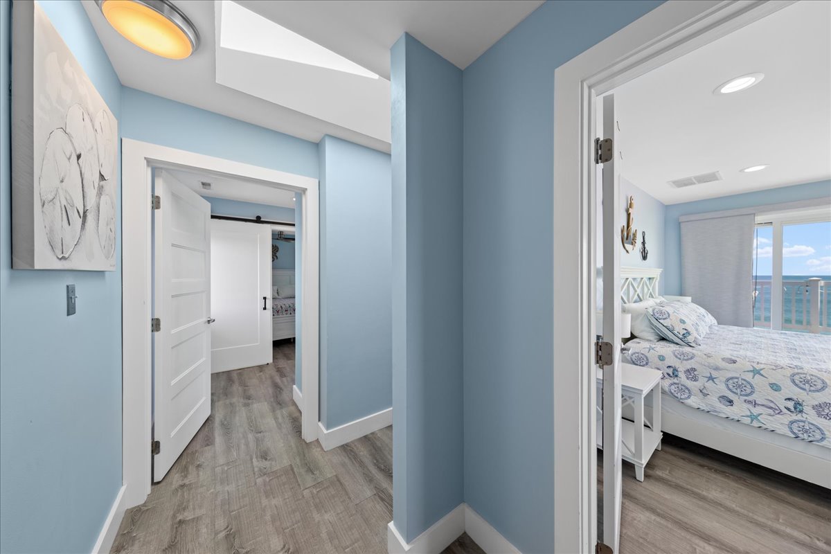 Gorgeous gray wood grain flooring and fresh coastal blue walls throughout the entire home.
