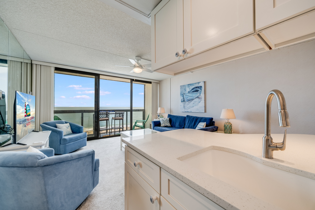 Enjoy open-concept living where the kitchen flows seamlessly into the living room and out to the ocean view.