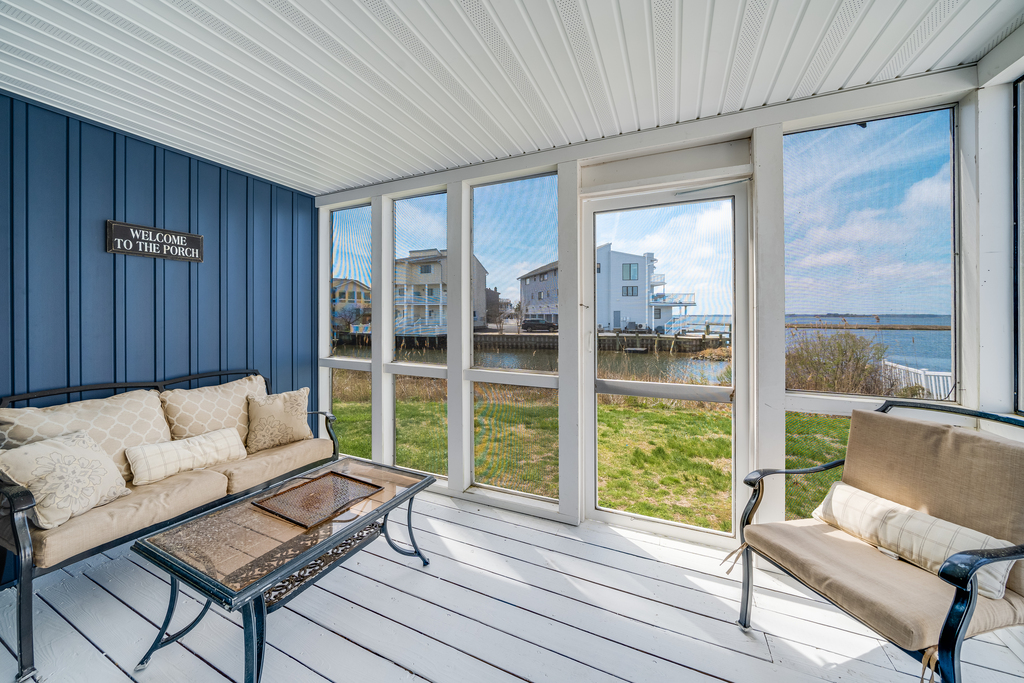 This cozy, screened in porch is located just off the living room.