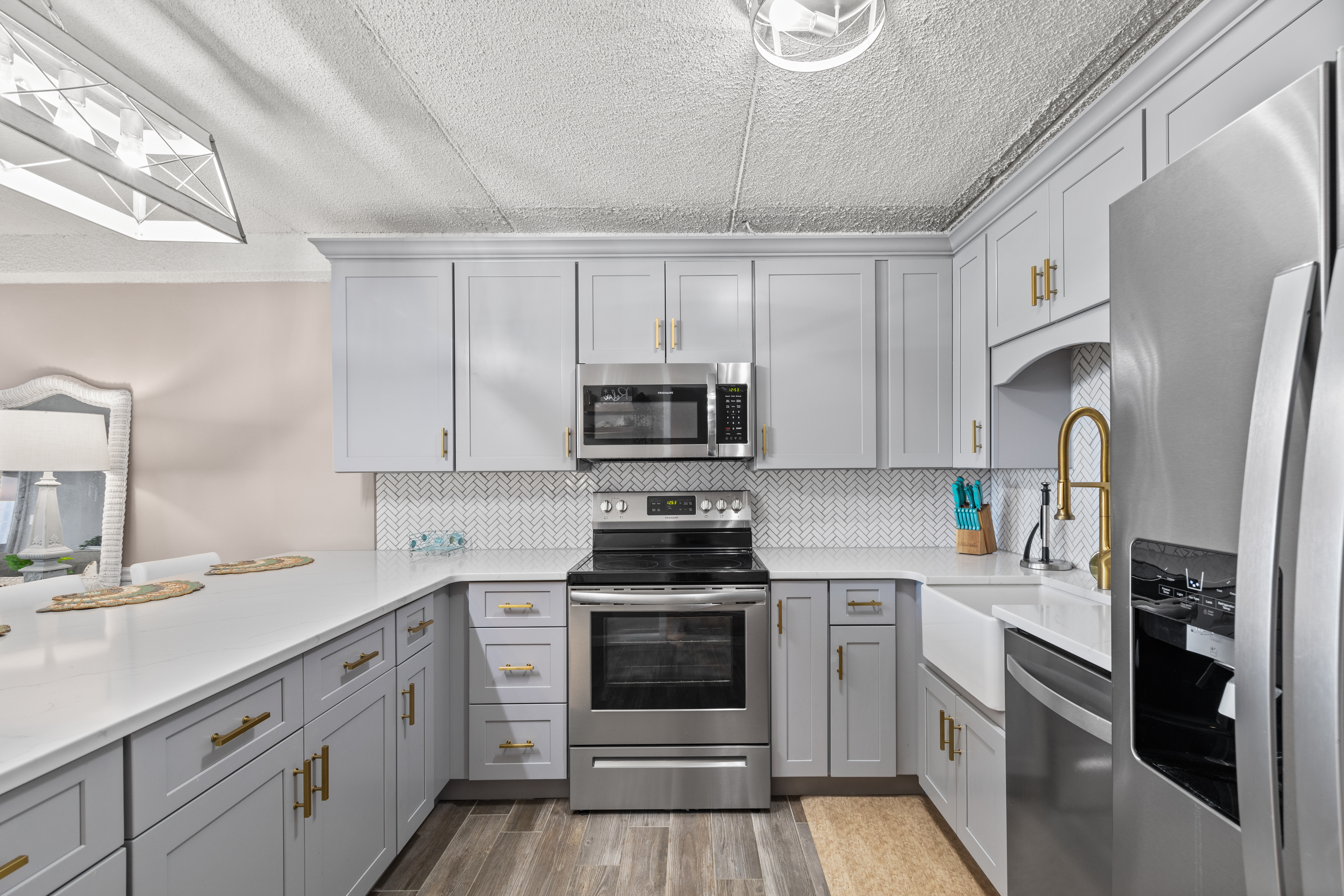 This Kitchen showcases sleek, top-of-the-line stainless steel appliances.