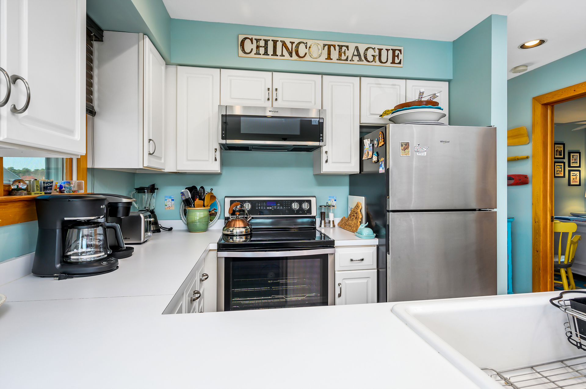 Adorned in Colors of Sea Glass with Stainless Appliances.