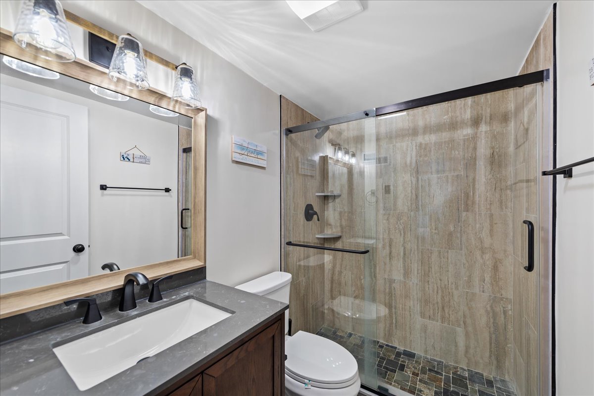 Wash away all the sand from your beach day in this spacious walk in shower in the Primary Bath.
