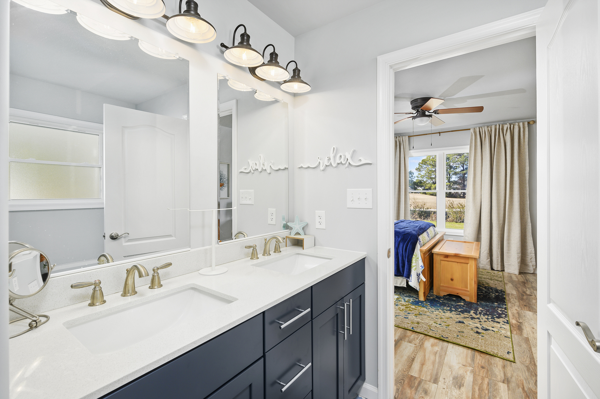Private Master Bath with Double Vanity adorned in Nautical Navy and White.