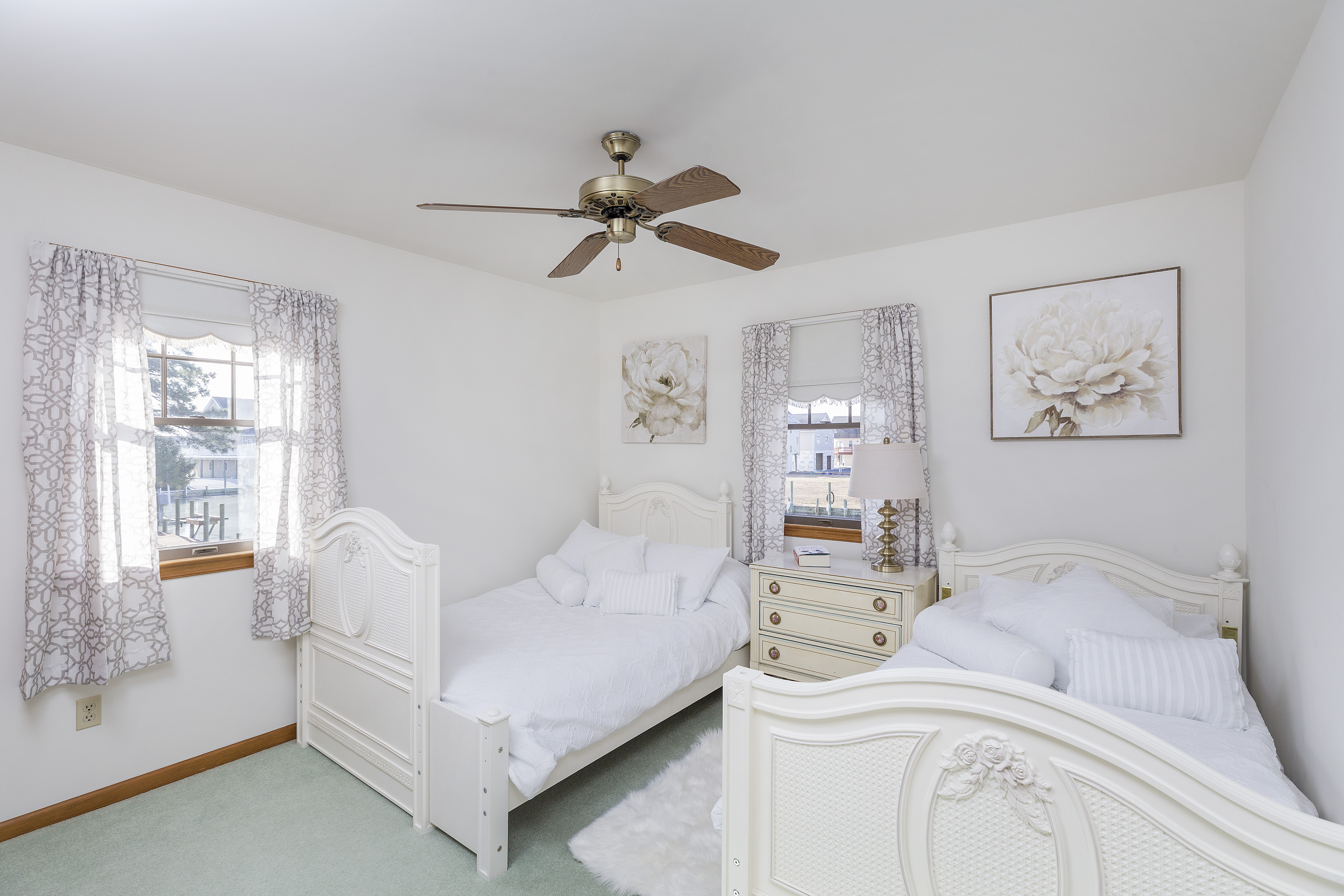 Bright White & Beachy Bedroom 1 on 1st Floor has a Twin Bed & Full Bed.