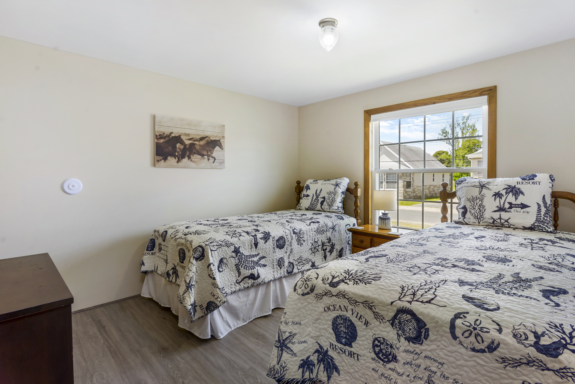Bedroom 2 has 2 Twin Beds & is adorned in Nautical Navy & Crisp White.