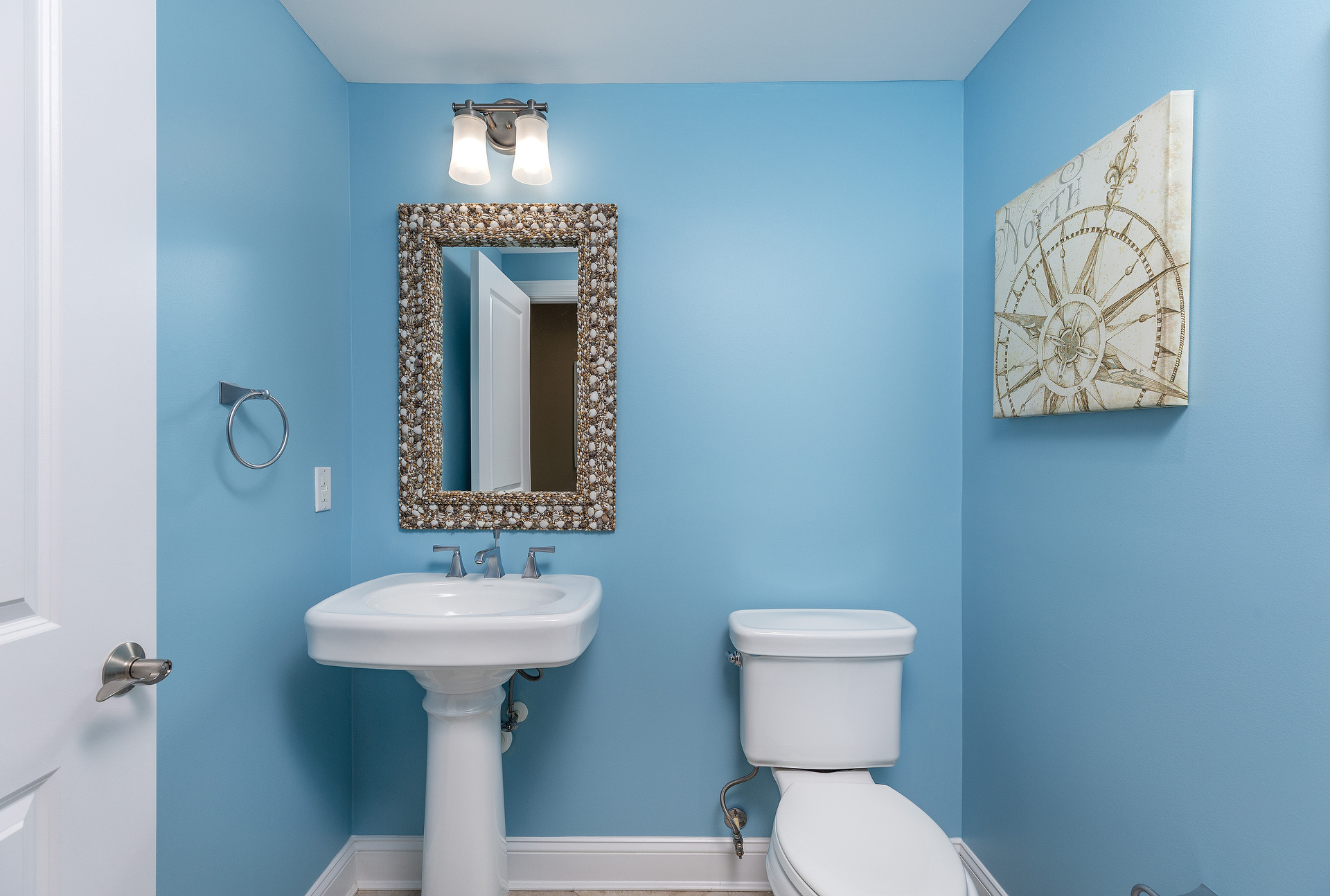 Lovely Half Bath is convenient to Living Area and Kitchen.