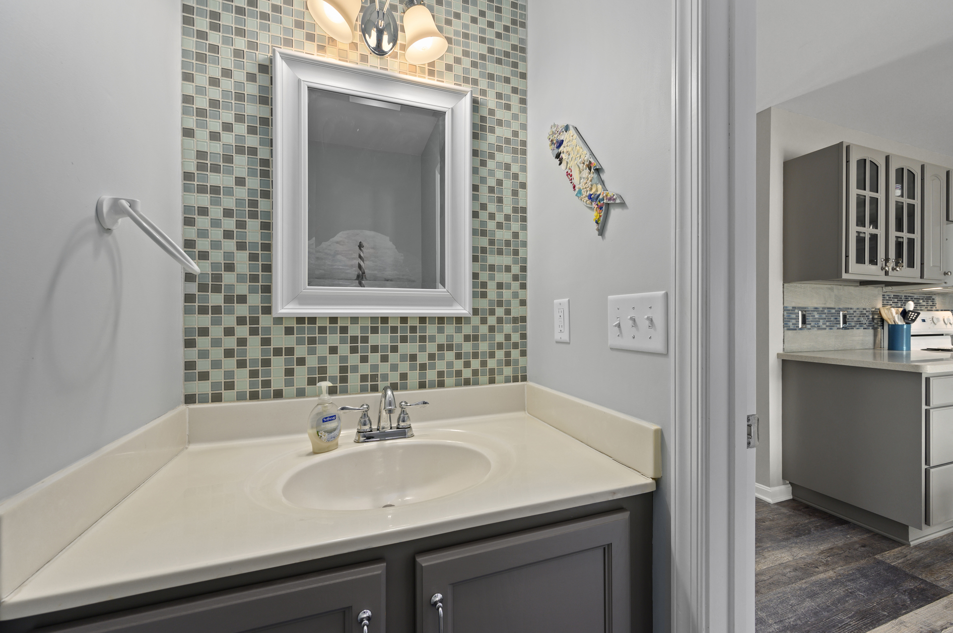 Stylish Half Bath is just off Living Area and Kitchen.