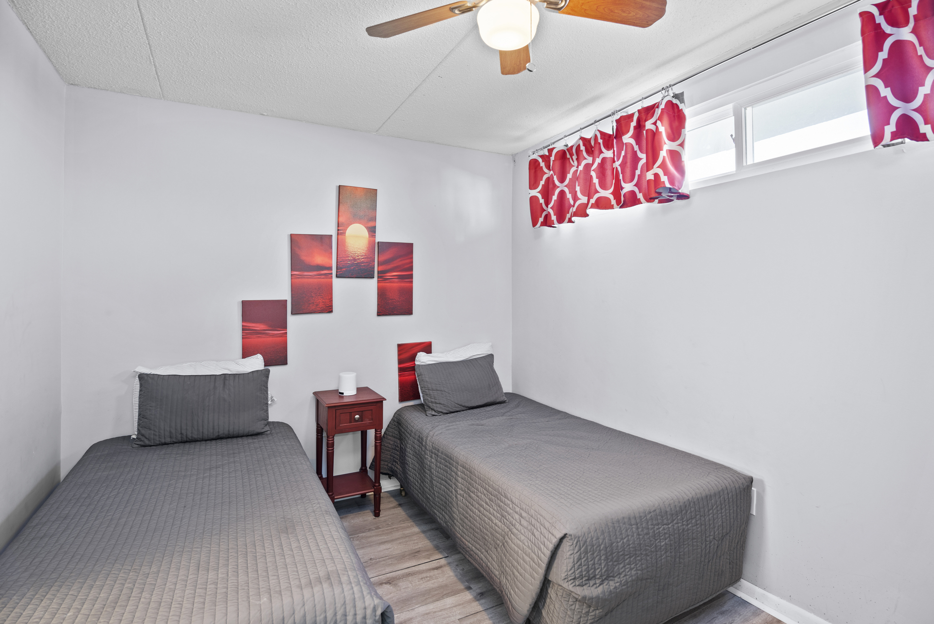 Bedroom 2 is adorned in Chic Gray & Nautical Red and has 2 Twin Beds and Flat Screen Cable TV.