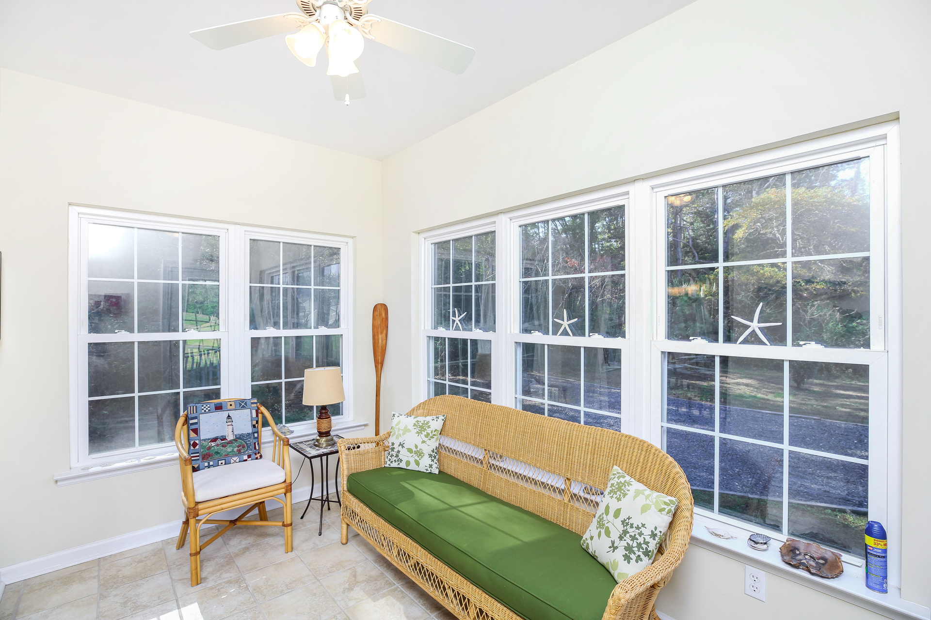 A bright & cheerful Sunroom lines the back of Blue Heron.
