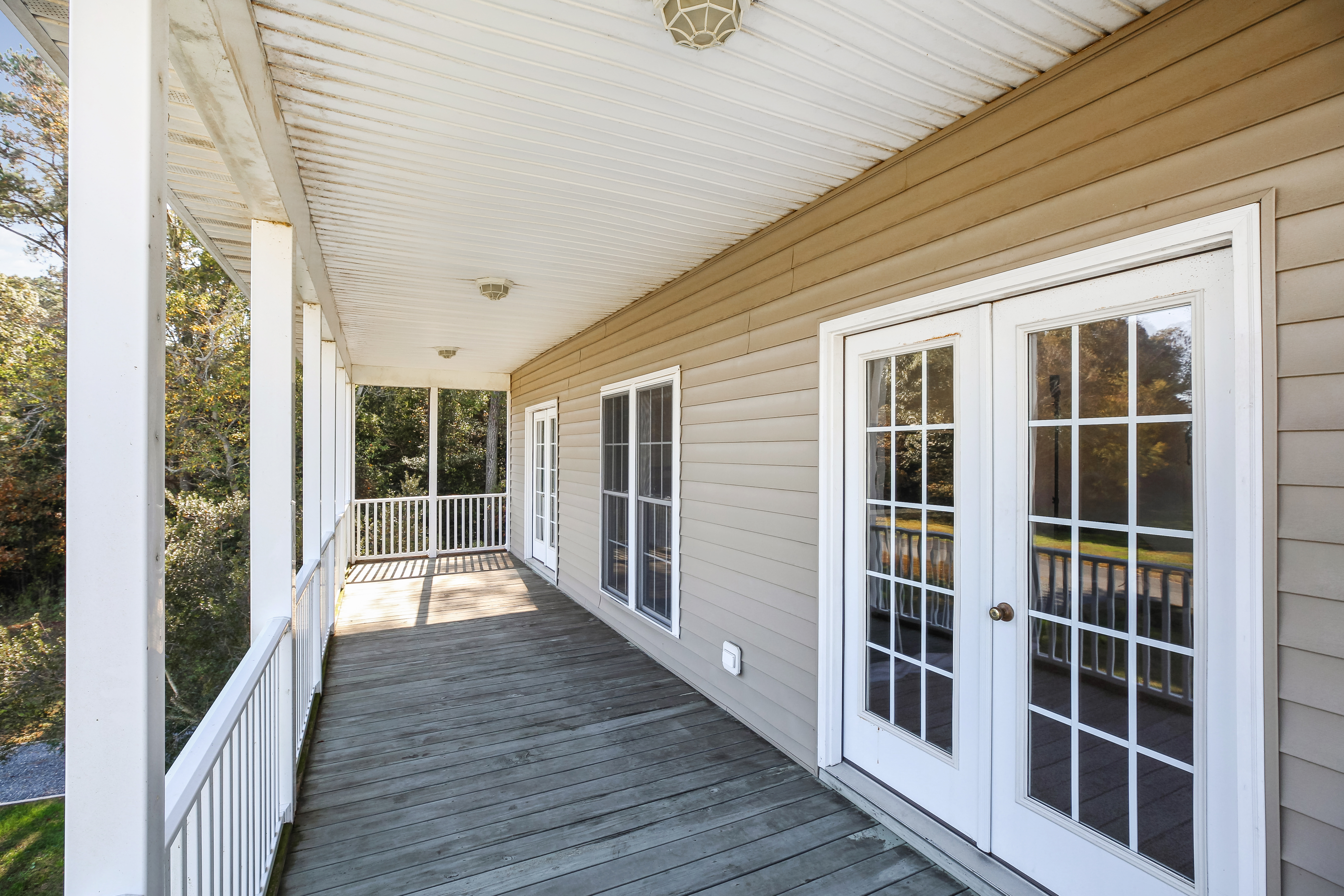 Front Porch is furnished with Country Rocking Chairs & comfortable Wicker Furniture.