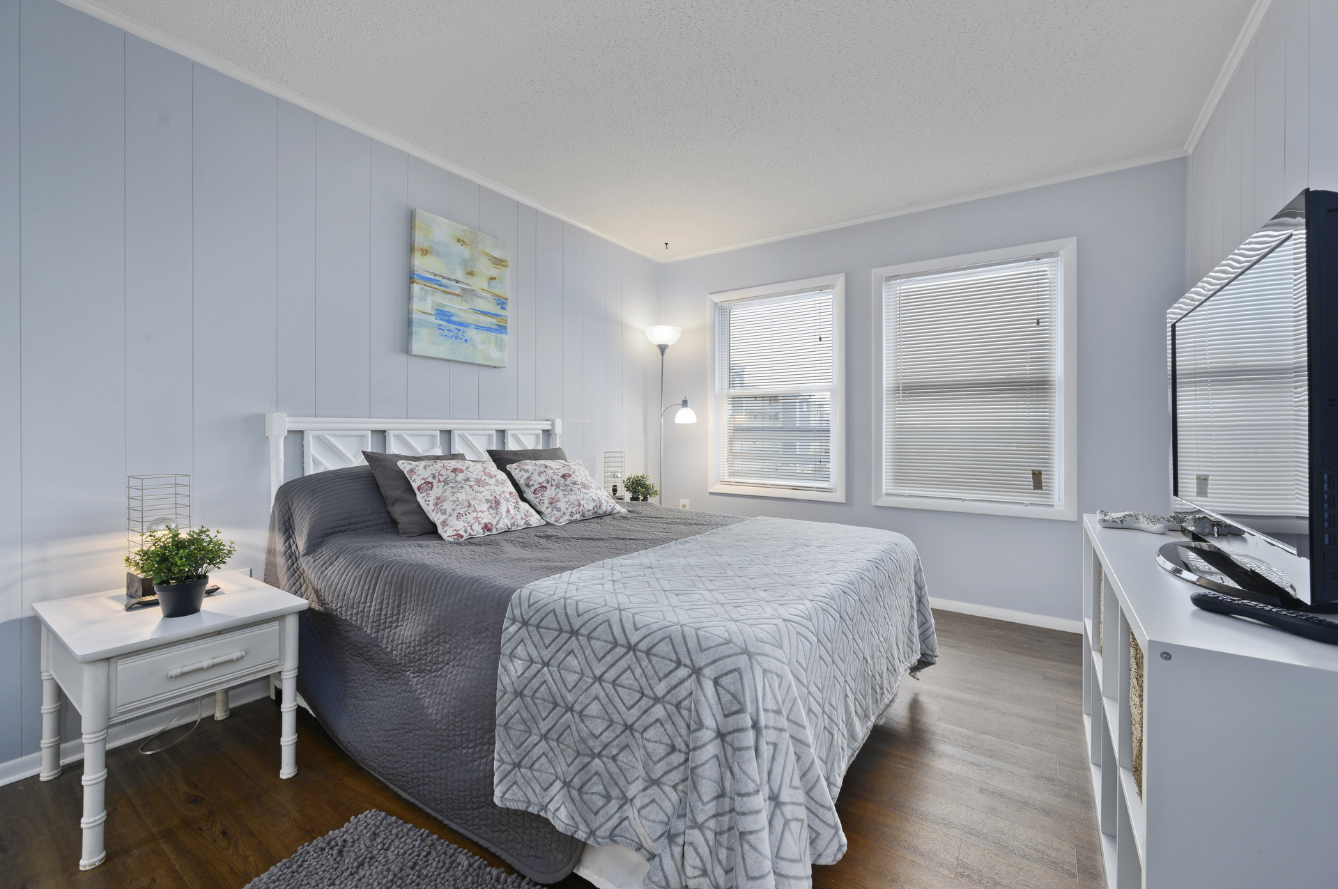 Beachy White Furnishings and a comfy Queen Bed are sure to delight.