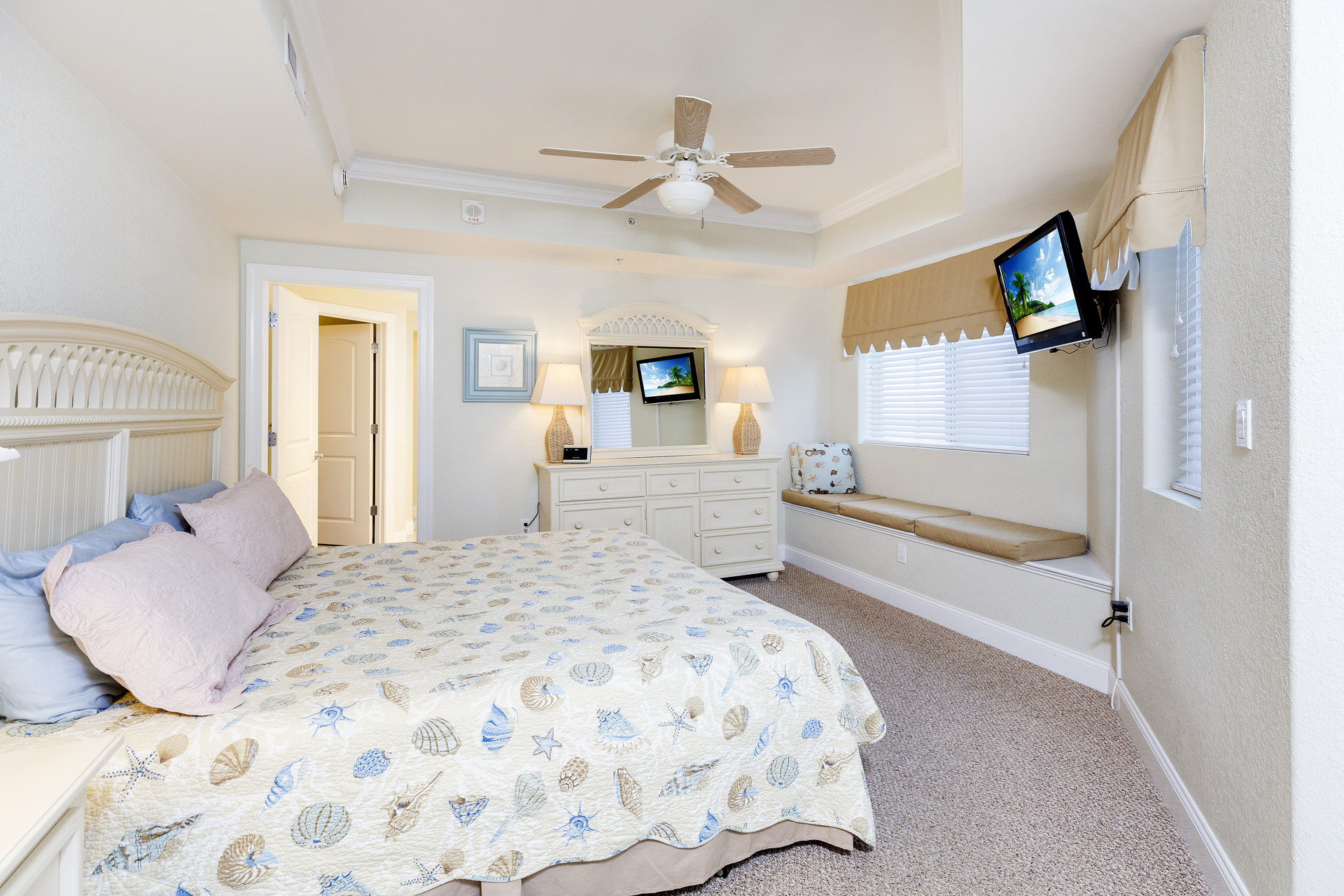Huge Primary Bedroom with Window Seat, Flat Screen TV, and King Bed.