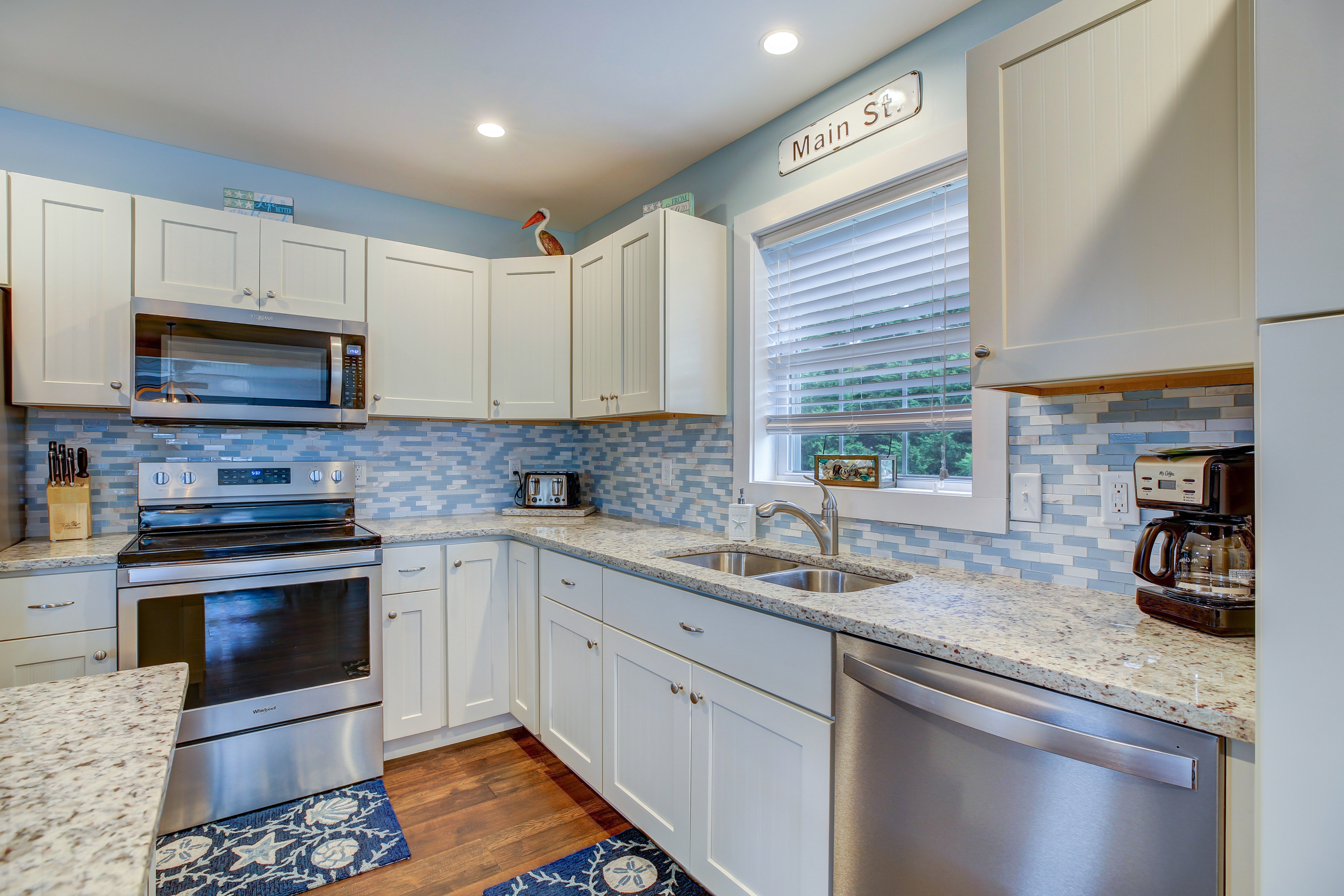 Gleaming Granite, Stainless Appliances, and just look at that Tile Back Splash.