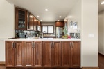 Fully-equipped kitchen with custom cabinetry and bar.