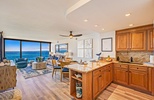 Mahana 1118’s kitchen offers granite countertops and warm wood cabinetry.