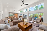 A bright, airy living room with vaulted ceilings — perfect for lounging between beach days.
