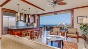 Spacious open-concept living area with gourmet kitchen, offering seamless island living and stunning views.