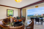Elegant dining space flows seamlessly to your private lanai, where tropical breezes and stunning ocean views create the perfect backdrop for memorable meals.