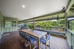 Gather for alfresco meals on the covered lanai, surrounded by tropical greenery and gentle breezes.