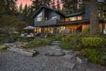 Experience lakeside magic as twilight falls over this elegant waterfront retreat, where luxury meets nature.