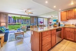 The kitchen at Papakea K-105 opens to light-filled spaces with calming views of lush garden greenery.
