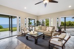Breezy French doors invite ocean air and natural light into the open-concept living room.