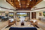 Vaulted ceilings and sliding glass walls create seamless indoor-outdoor flow in the expansive great room.