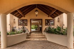 Elegant entrance with a covered walkway leading to the main house.