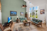 Expansive picture windows fill the living room with natural light, creating a bright and inviting space.