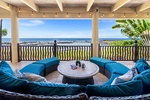 Oceanfront lanai with plush seating and panoramic views—perfect for morning coffee or sunset cocktails.