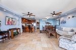 Living area with TV and cozy seating, adjacent to the kitchen and dining areas.